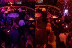 Pareja conectando en evento nocturno de Match Match Agency, rodeados de invitados internacionales.