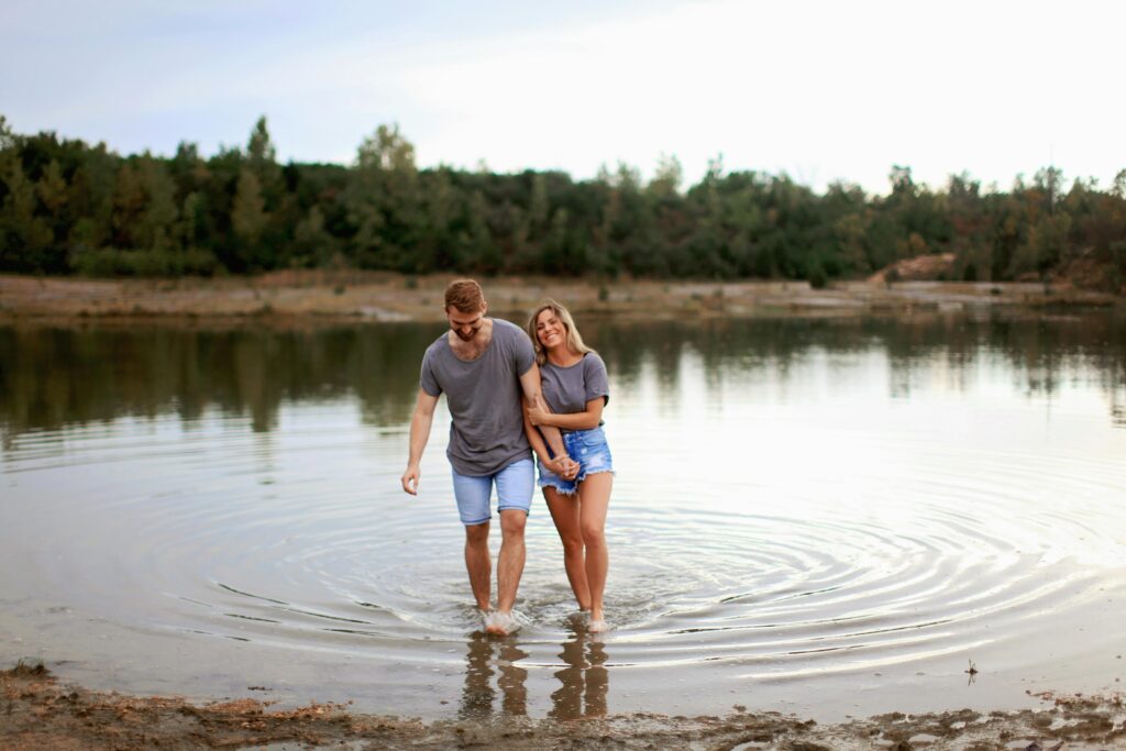 pexels-photo-1449668-1449668 Happy couple walking together by a serene lake, expressing love and joy.
